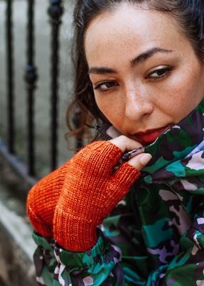 girl wearing orange fingerless gloves